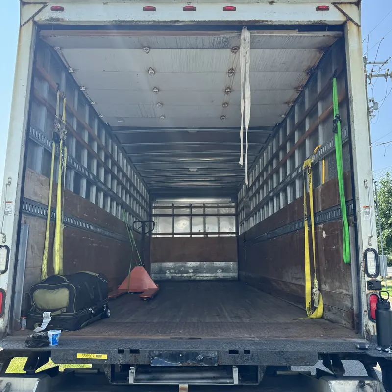 Box truck interior with load straps ready for a relocation