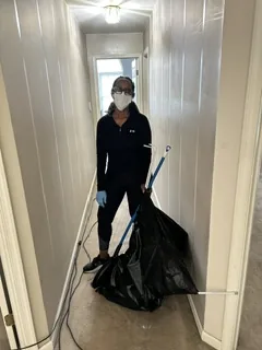 Crew member cleaning a hallway during an estate cleanout
