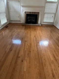 Empty, clean living room with hardwood floors after an estate cleanout