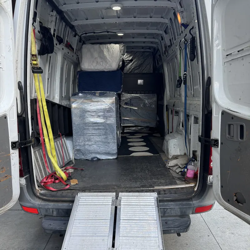 Furniture wrapped in protective pads inside a cargo van