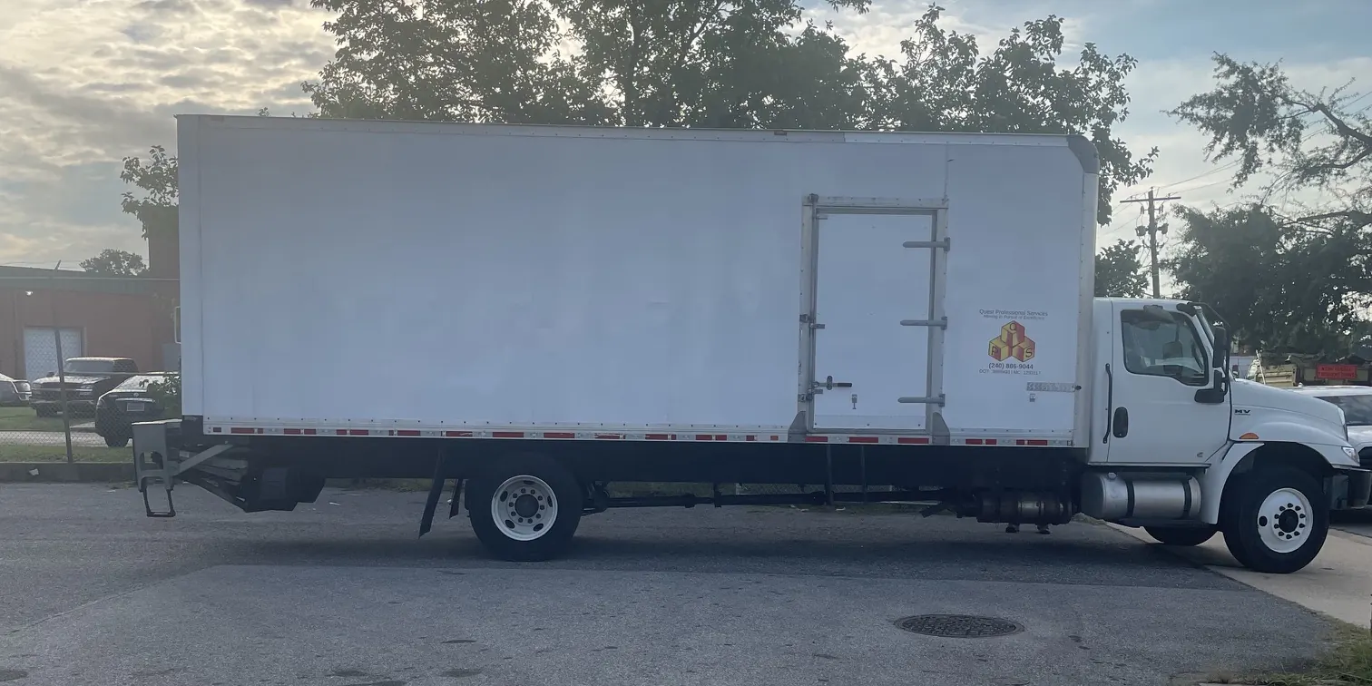 Quest Professional Services box truck parked in a lot