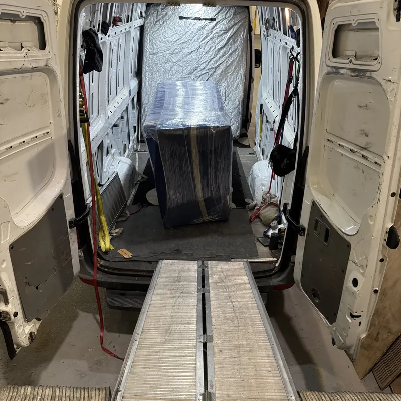 Wrapped furniture ready for delivery in a cargo van